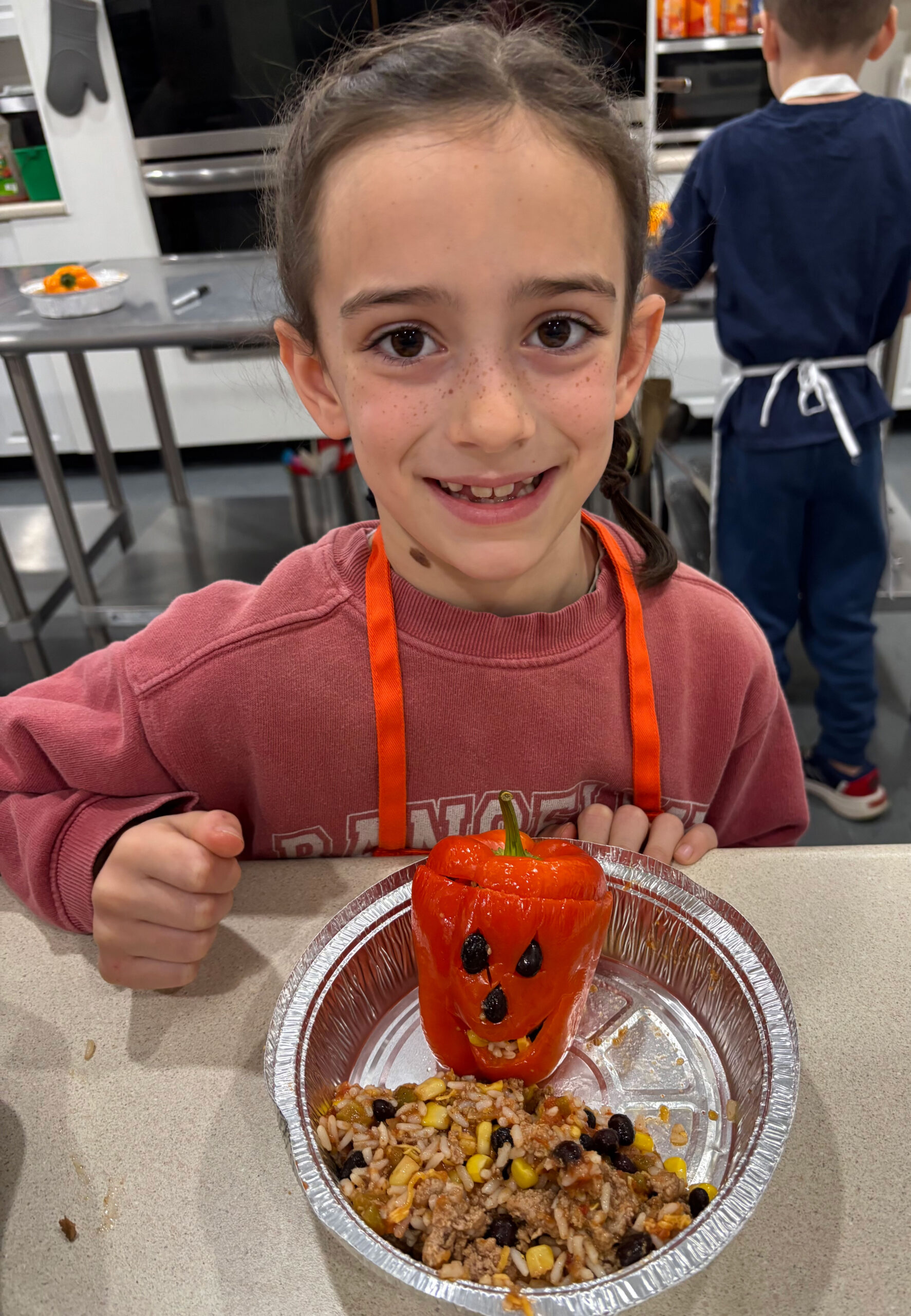 Young girl smiling and posing with food she made