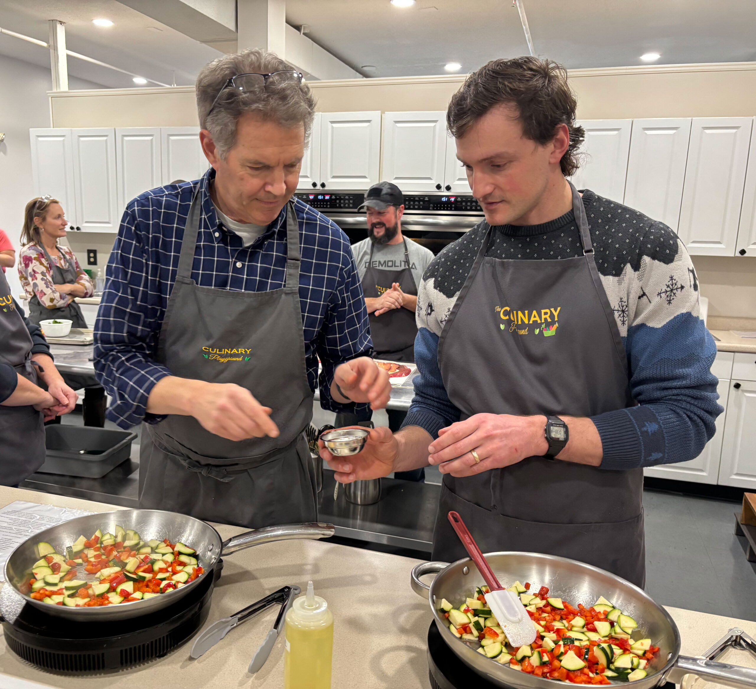 Two men measuring ingredients 